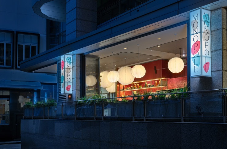 The front facade of Monopole restaurant at night